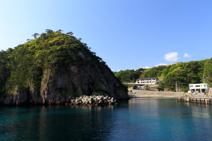 Scenic Shikinejima cliffs overlook turquoise bay.