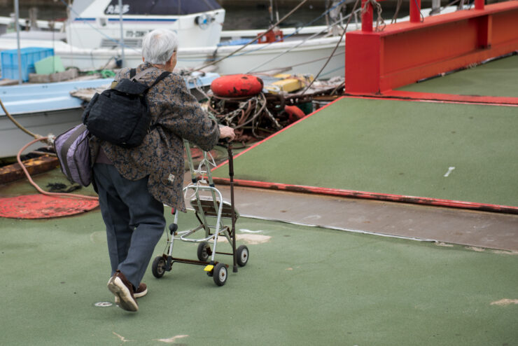 Elderly walker-assisted marina navigation.