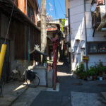 Narrow Japanese alleyway showcases historic architecture charm.