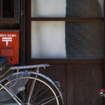 Nostalgic Japanese street scene with bicycle blossoms.