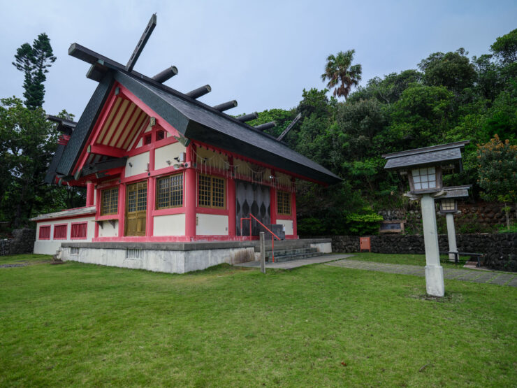 Traditional Japanese shrine architecture captivates amidst nature.