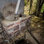 Decaying smallpox isolation ward fireplace remnants.