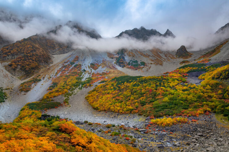 Vibrant autumn mountain vista, misty peaks