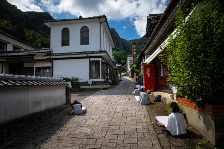 Historic Japanese street, mountain backdrop