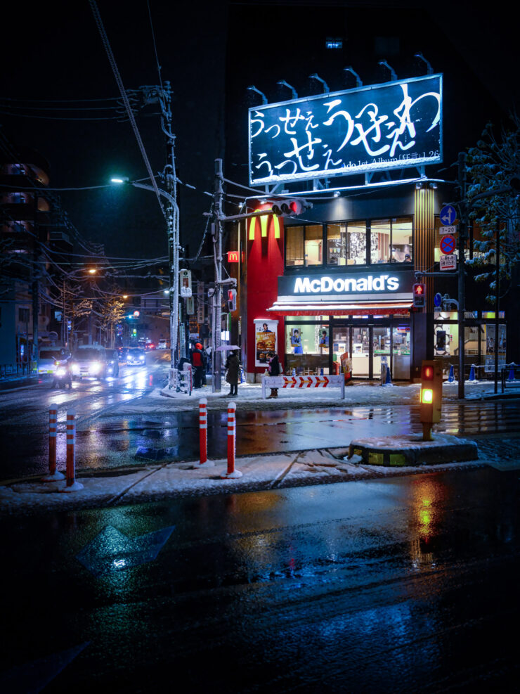 Atmospheric rainy night McDonalds streetscape.