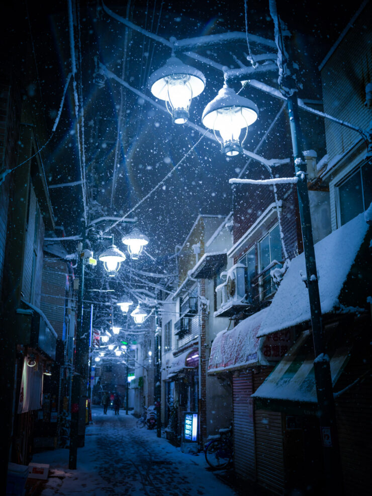 Enchanting snowy Tokyo alleyway at night