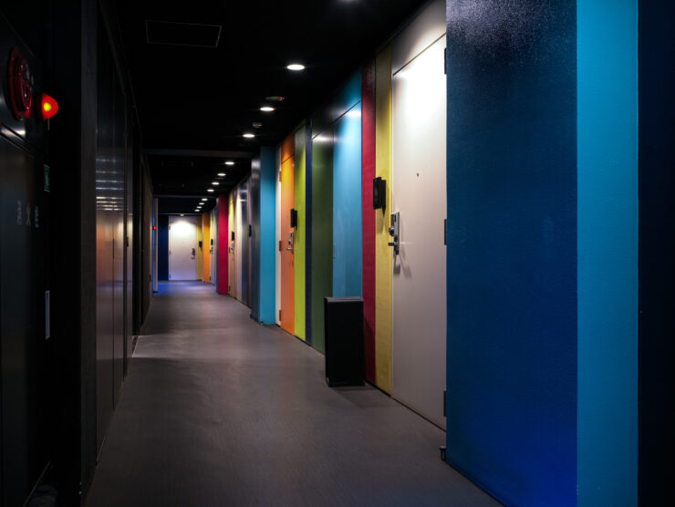 Vibrant coworking corridor, colorful doors.