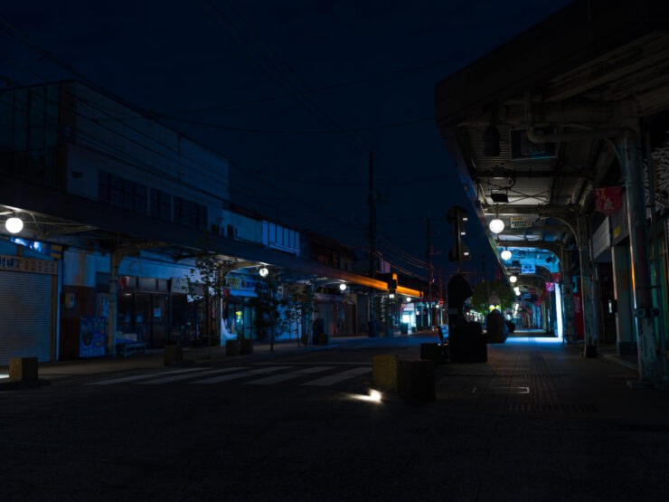 Illuminated whimsical street with Mizuki Shigerus bronze sculptures