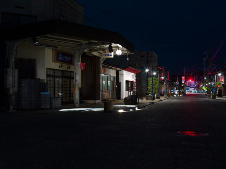 Whimsical Nighttime Sakaiminato Street with Manga Statues