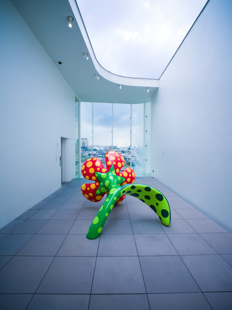 Vibrant polka dot sculpture installation, minimalist gallery.