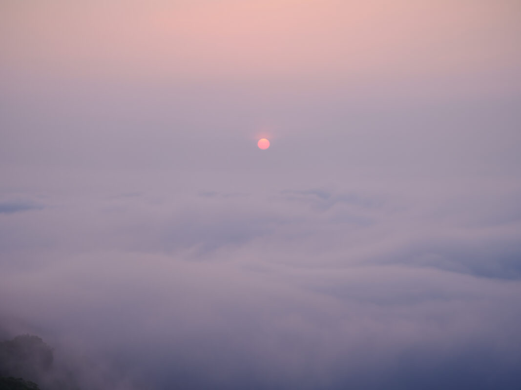 Pastel sunrise above a sea of clouds at Unkai Terrace mountain viewpoint.
