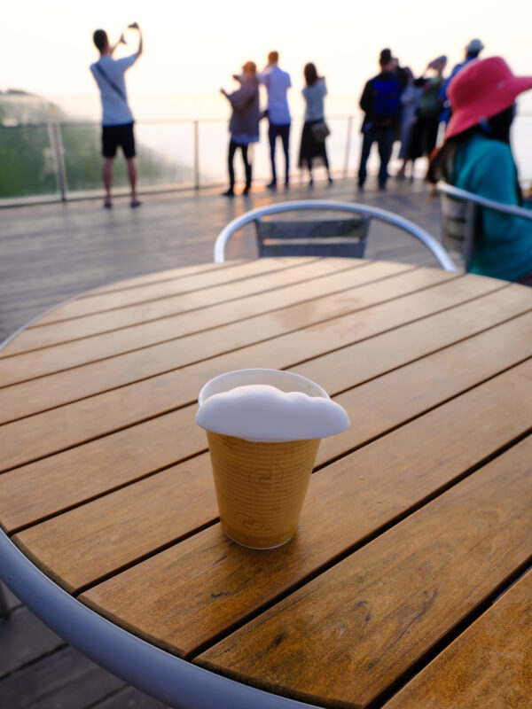 Cloud foam latte on Unkai Terrace mountain viewpoint with visitors overlooking misty mountains