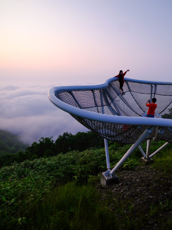Crescent Unkai Terrace viewpoint above sea of clouds at sunrise with two visitors