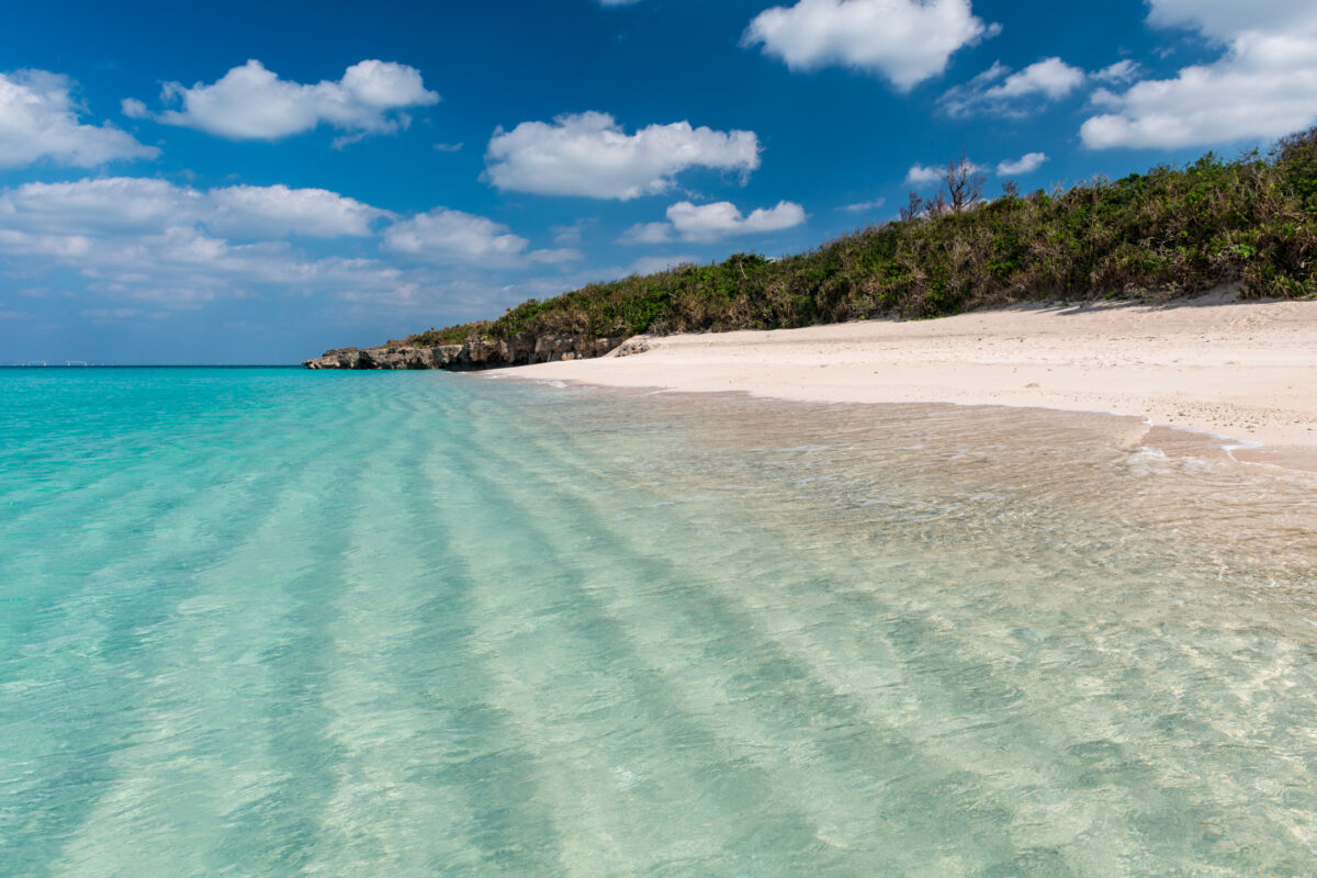 Miyako Island white sand beach with clear turquoise lagoon and blue sky