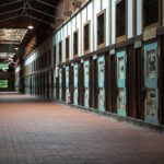 Abashiri Prison corridor in Hokkaido, Japan with rows of weathered wooden cell doors