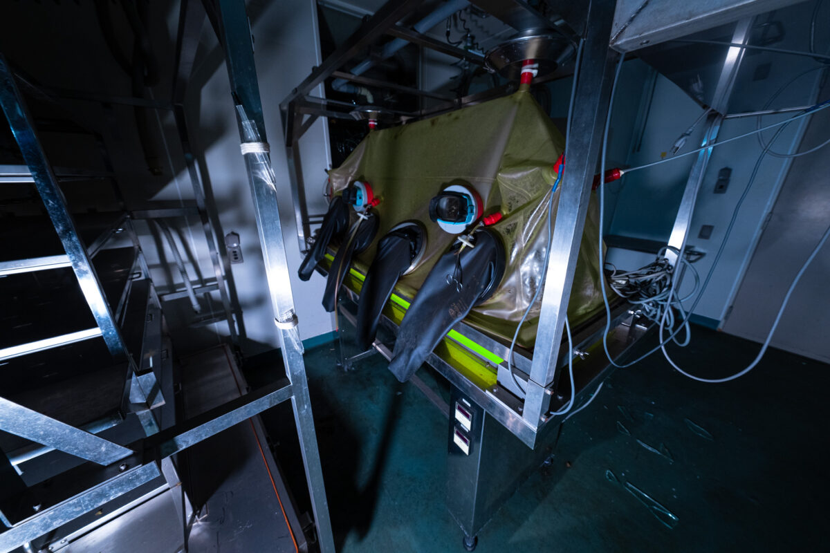 Sealed glovebox chamber for animal research with built-in gloves and metal frame.