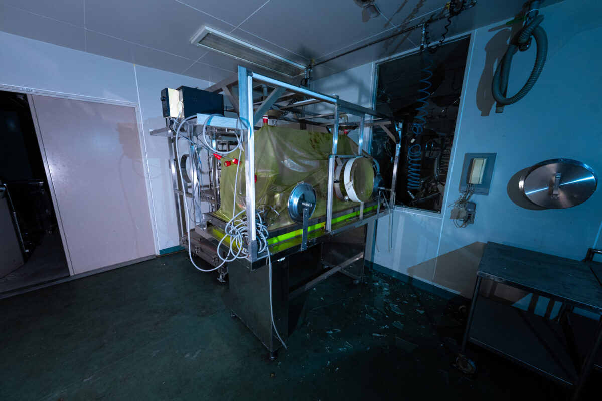 Sterile animal research lab with clear containment chamber, tubes, and monitoring equipment.