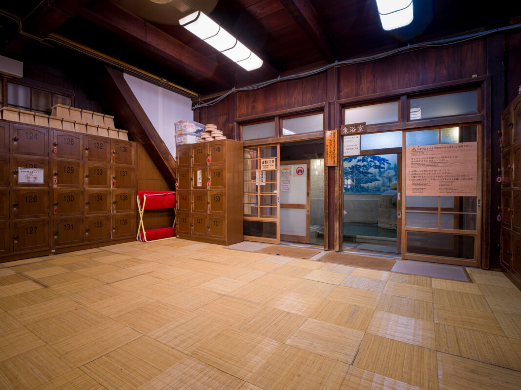 Dōgo Onsen tatami entry room with numbered wooden shoe lockers and sliding doors