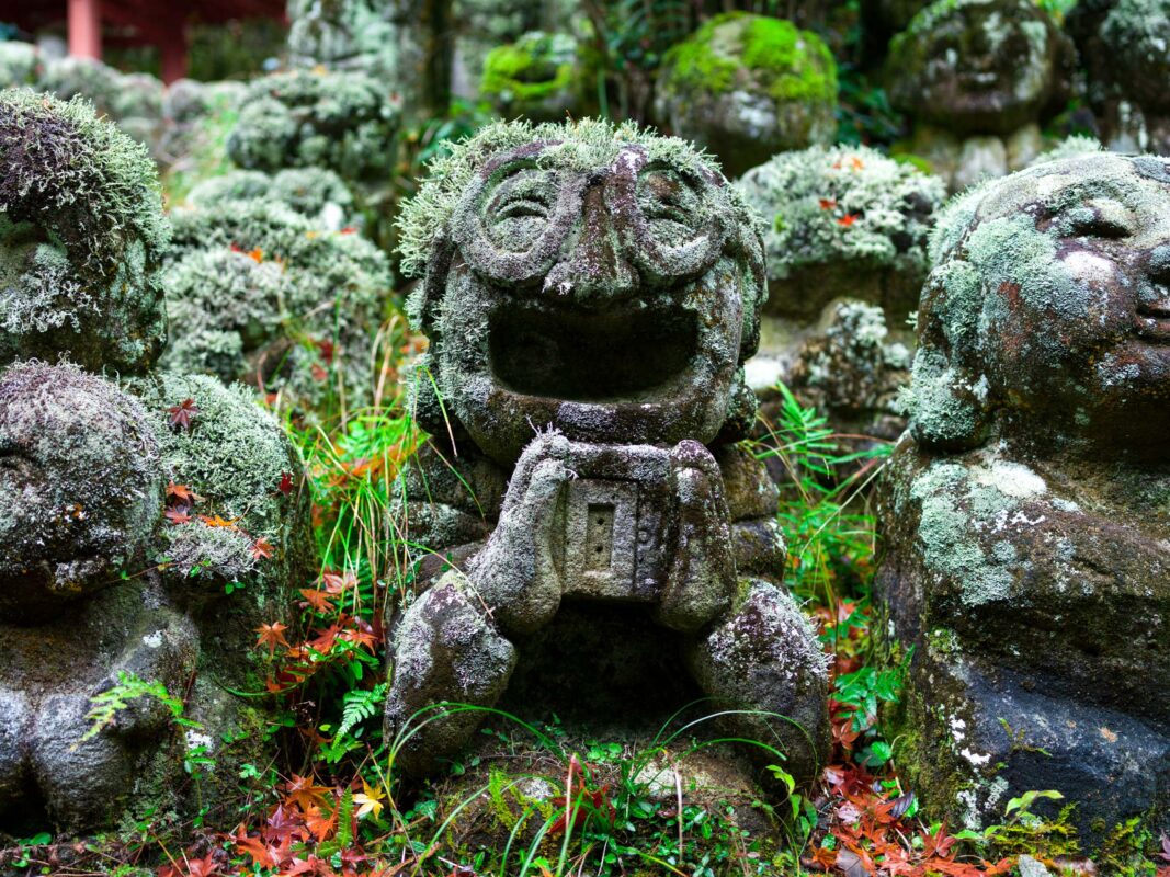 Moss-covered stone Buddha statues at Otagi Nenbutsu-ji temple in Kyoto, Japan.