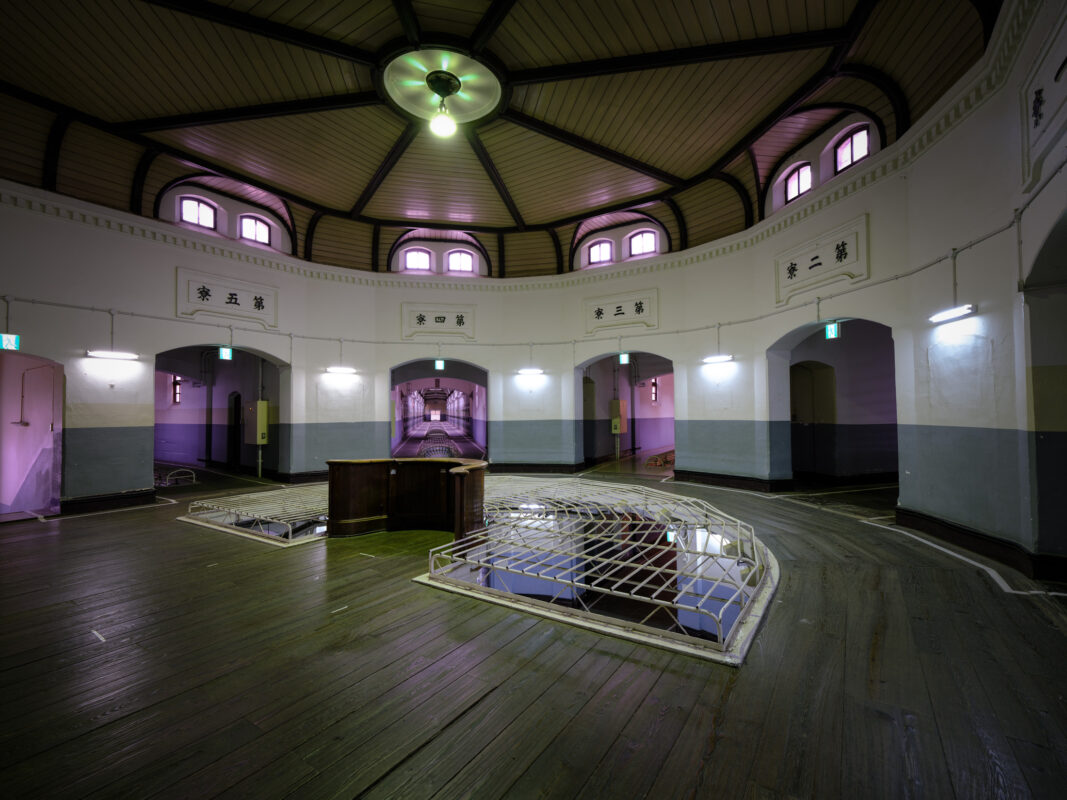 Wide-angle view of Nara Prison rotunda interior with domed ceiling and arched doorways