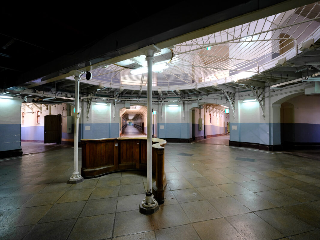 Nara Prison rotunda with central guard desk and radiating corridors under skylight