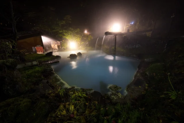 A magical night at an abandoned onsen, where milky blue waters blend with glowing lights in a peaceful forest. Tradition and nature meet in this perfect spot for relaxation and serenity.幻想的な夜、廃墟の温泉で。乳白色の水と光が森の中で静かに調和しています。伝統と自然が融合し、リラックスと穏やかさがここにあります。#onsen #japantravel #serenescape #traditionmeetsnature #abandonedplaces #offbeatjapan #japan